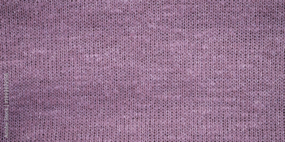 Fototapeta premium Knit fabric in soft purple color displayed on a flat surface during the day
