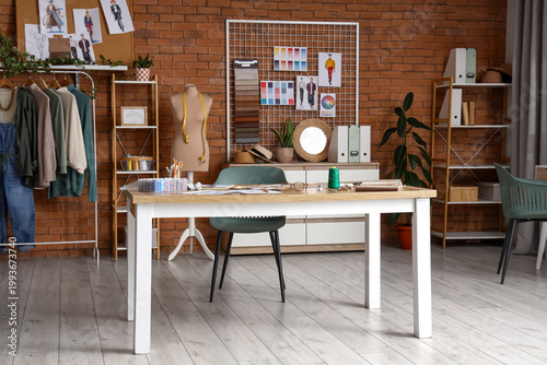 Fotografía Interior of fashion designer's studio with workplace, mannequin and pin board