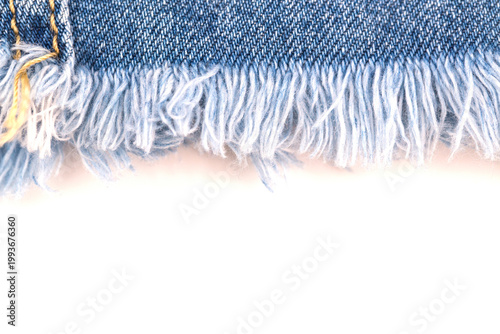 Bild auf Leinwand Denim fabric with frayed edges on a white background showing detail of texture a