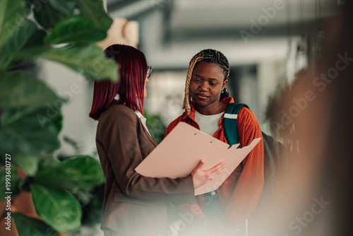 Canvas Print University advisor and student engaging in a mentorship session, reviewing docum