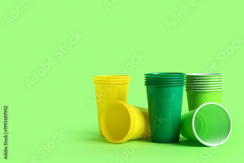 Different plastic cups on g...