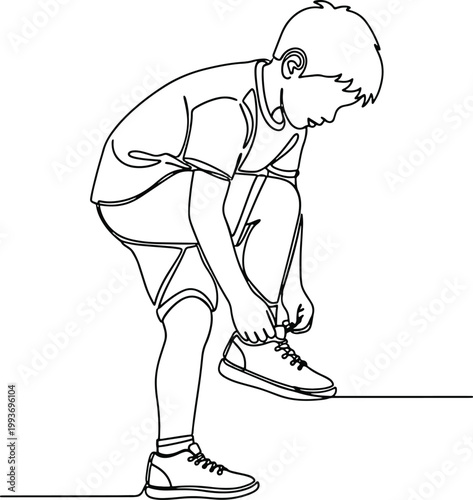 boy tying his shoe laces