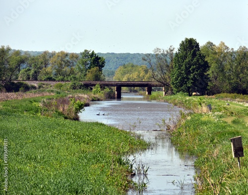 A bridge over a stream in the countryside.