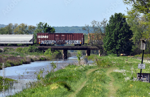 A train going over a bridge with water underneath.