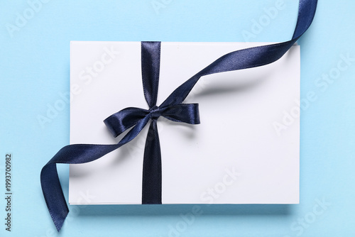Blank card with bow on blue...