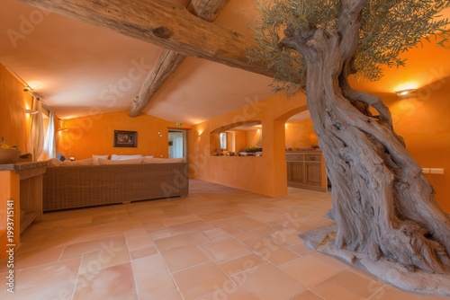 Rustic Interior with Olive Tree: A captivating interior space blends rustic charm with nature. An old olive tree trunk rises, casting an intriguing silhouette across the room.