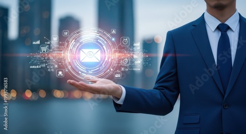 Businessman holding a digital email icon interface with holographic business data