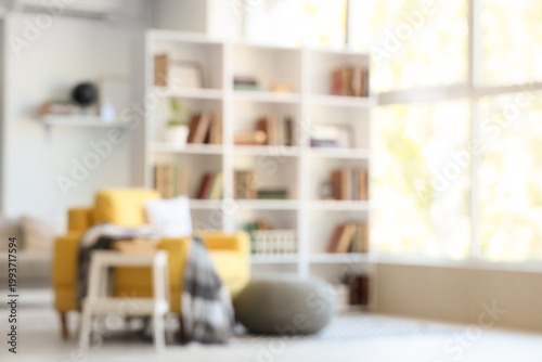 Cuadro en lienzo Blurred view of stylish living room with yellow armchair, pouf and bookshelf
