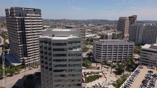 alt view of downtown Glendale CA flying back over American flag