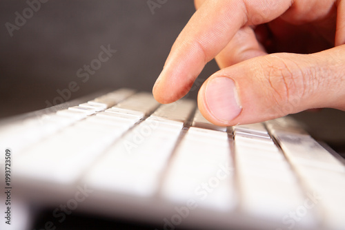 man 's hand with a white keyboard on a white background