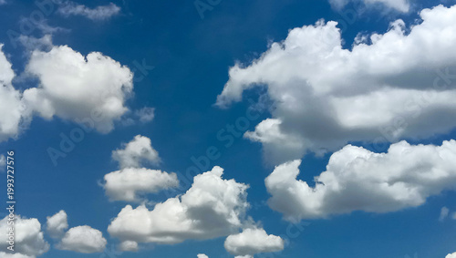 Wide Angle Blue Sky with Fluffy White Cumulus Clouds.