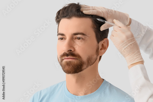 Doctor giving man injection...