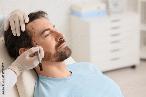 Doctor applying marking on ...
