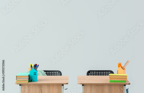 Modern school desks with bo...