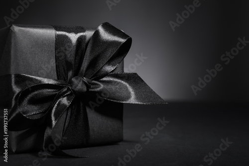 Black gift box on dark back...