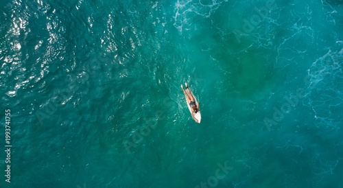 Aerial view of the ocean and surfer girl. Surfing in Midigama. Sri Lanka