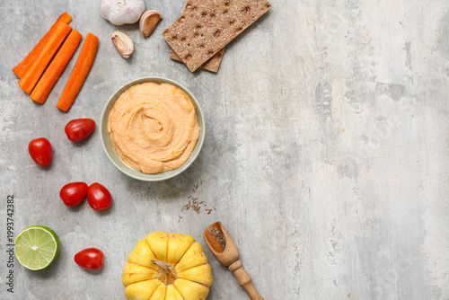 Bowl of tasty hummus with c...