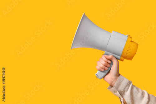 Female hand with megaphone ...
