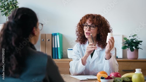 Video of cheerful nutritionist woman explaining medical treatment to patient in the consultation.