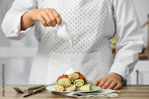 Woman pouring sour cream on...
