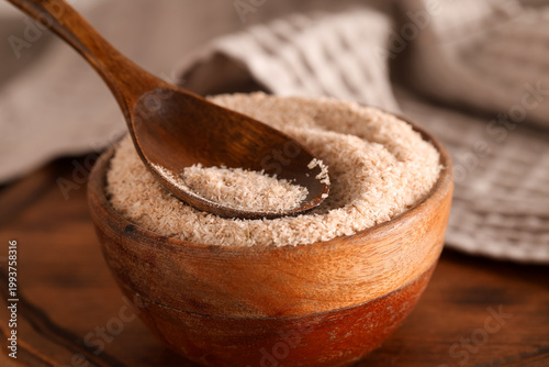 Fotografie Bowl with psyllium husk powder on table, closeup