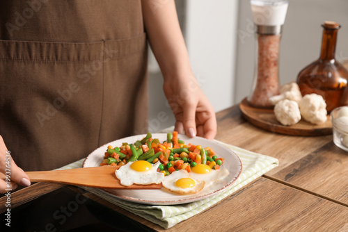 Woman preparing tasty dinne...