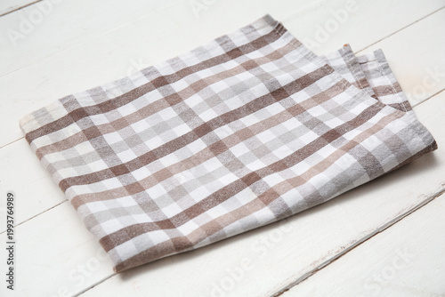 Brown checkered napkin on w...