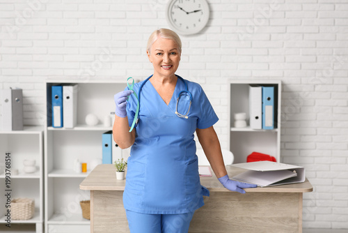 Mature female doctor with t...