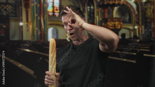 Canvas Print Man smiling while holding a baguette and making ok hand gesture in church building; faith contrast playful