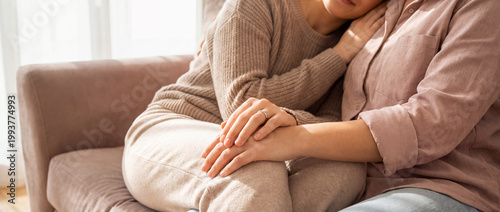 support comfort embrace tenderness cozy home trust connection warmth care quiet cuddle on a sofa with hands on the lap shows trust affection and emotional safety for relationship wellness themes