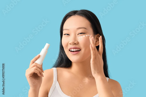 Young Asian woman applying ...