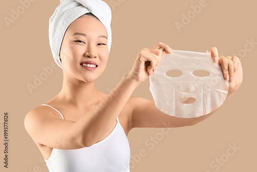 Young Asian woman in towel ...