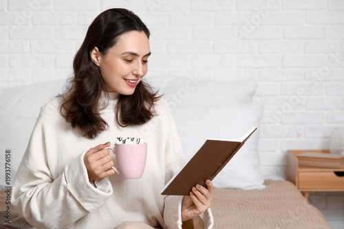 Young happy woman with cup ...