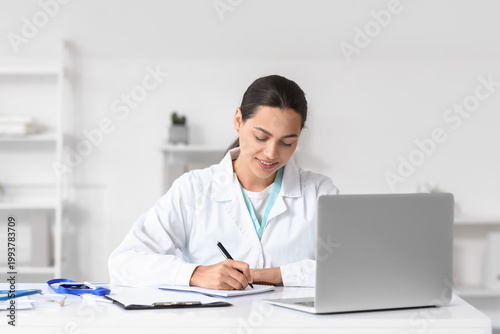 Female doctor writing notes...
