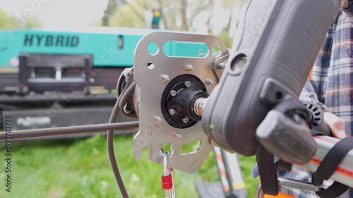 Close-up of tool attachment on metal plate near hybrid truck