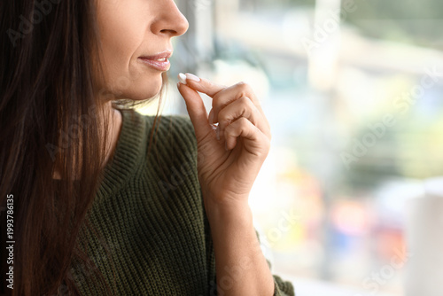 Beautiful woman taking pill...