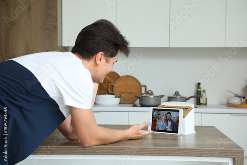 Young man video chatting wi...
