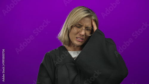 Photos Blonde woman judge adjusts glasses and hand on temple for headache in a studio; stress anxiety tension