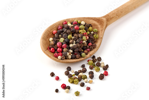 Mixed peppercorns in wooden spoon, isolated on white background