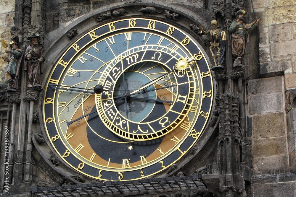 Obraz premium Close-up of the medieval Prague Astronomical Clock or Orloj with its astronomical dial and moving statues of a skeleton and a Turk on the Old Town Hall wall in Prague, Czech Republic