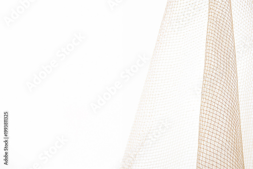 Light brown mesh fabric creating abstract texture background