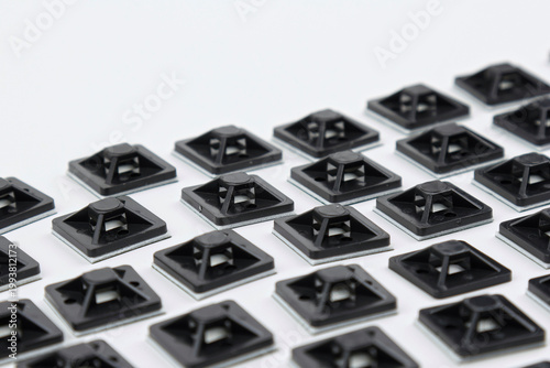 Plastic self-adhesive pad for installing nylon ties.