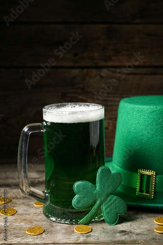 Glass of green beer with cl...