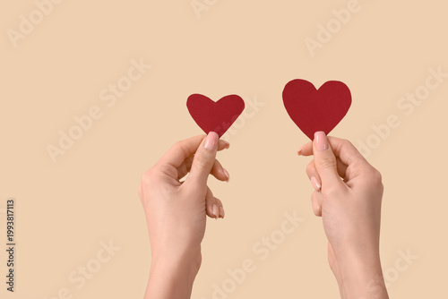 Female hands with paper hea...