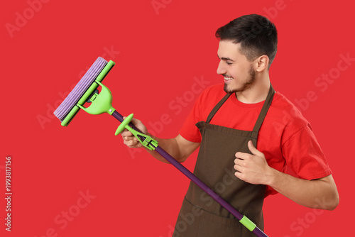 Male janitor with floor mop...