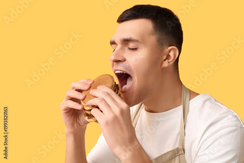 Young man eating tasty home...