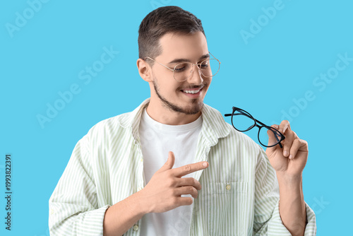 Young man pointing at eyegl...