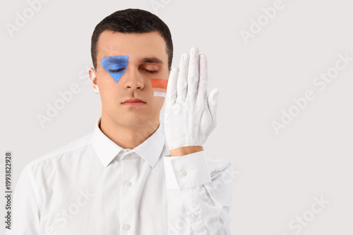 Young man with painted face...
