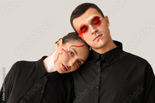 Young couple with painted f...