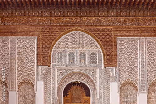 Lavishly carved wood and richly sculpted stucco, NW facade housing the screen doorway to the Ben Youssef Madrasa courtyard. Marrakesh-Morocco-316